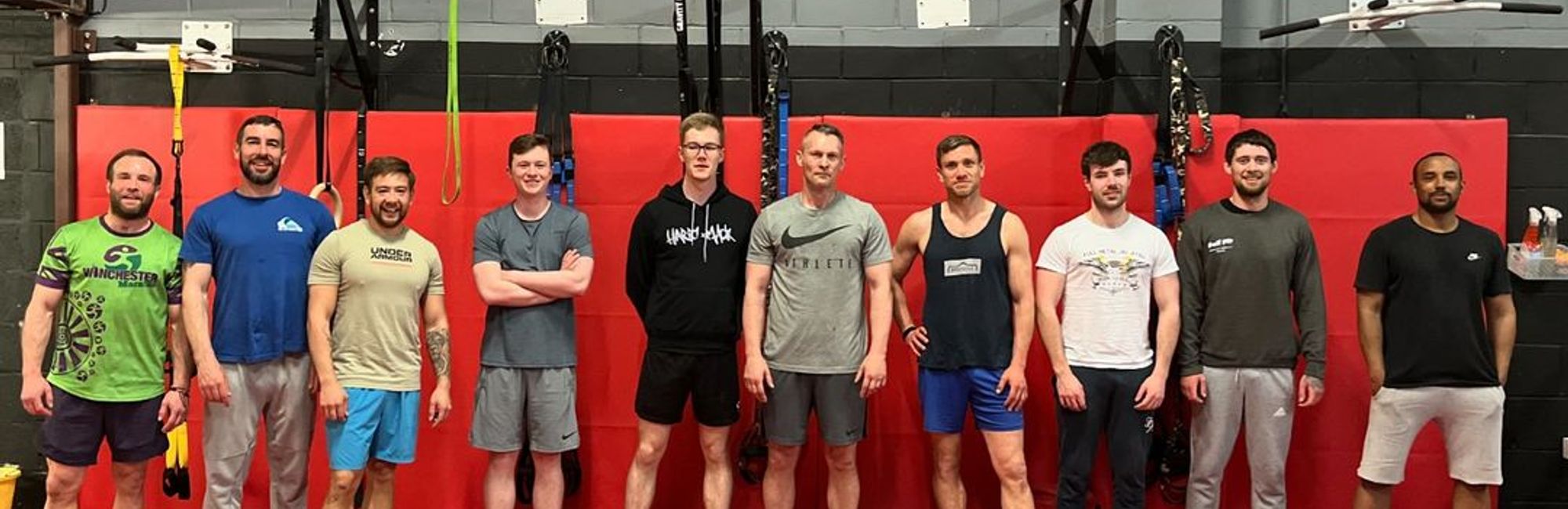 an all-levels class at Cali Fit, with a full number of members posing for a photo