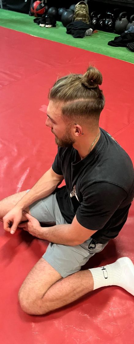 A calisthenics gym member resting on the floor